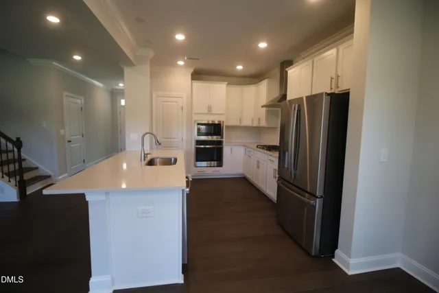 a kitchen with stainless steel appliances a refrigerator and a sink