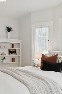 a bedroom with a bed a mirror and a table