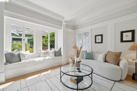 a room with table chairs and a view of living room