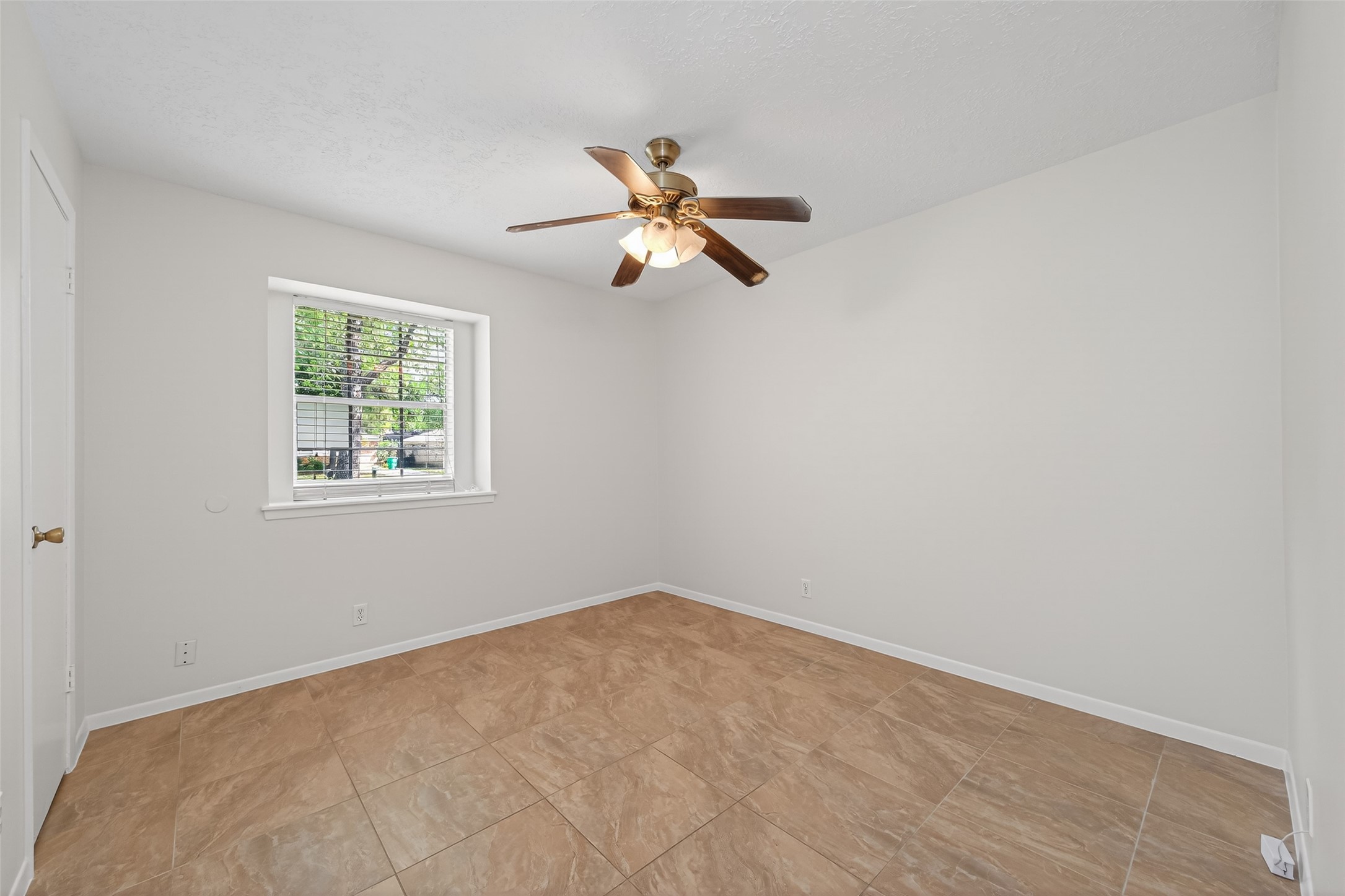 23919 Farm Hill Drive Spring, TX 77373 - Photo 25 of 41 a view of a room with a ceiling fan and a window