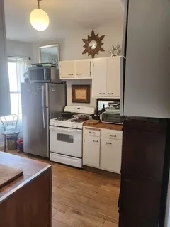 a bedroom with a bed couch and a window