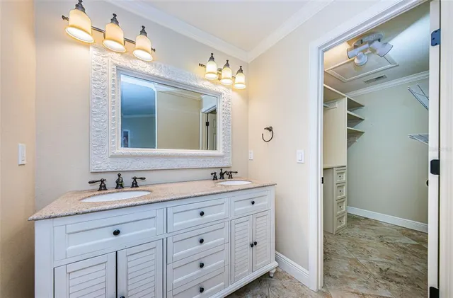 a bathroom with a granite countertop sink mirror and vanity