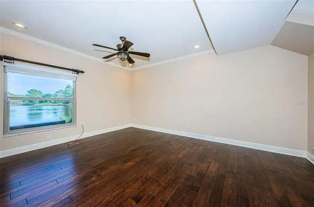 a view of a hallway with wooden floor and front door