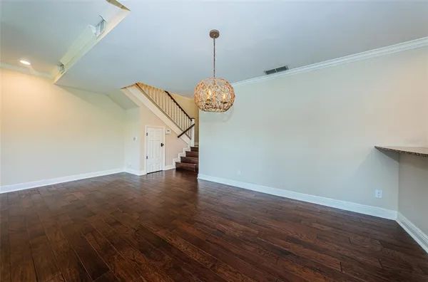 a kitchen with stainless steel appliances granite countertop white cabinets a microwave a sink and a counter space