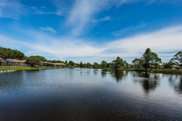 an empty room with wooden floor a ceiling fan and wooden floor