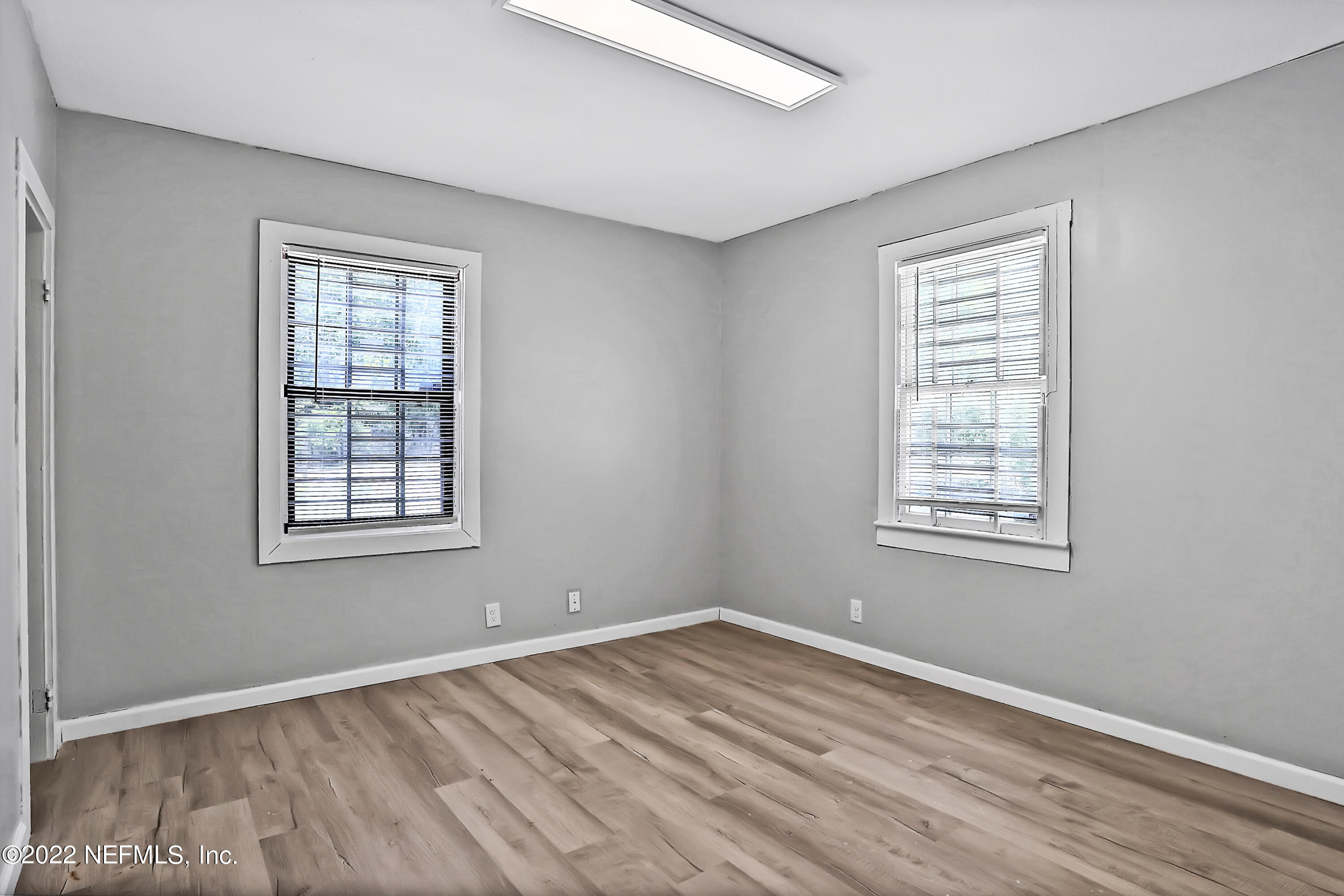 5645 St Augustine Road Jacksonville, FL 32207 - Photo 5 of 11 a view of an empty room with wooden floor and a window