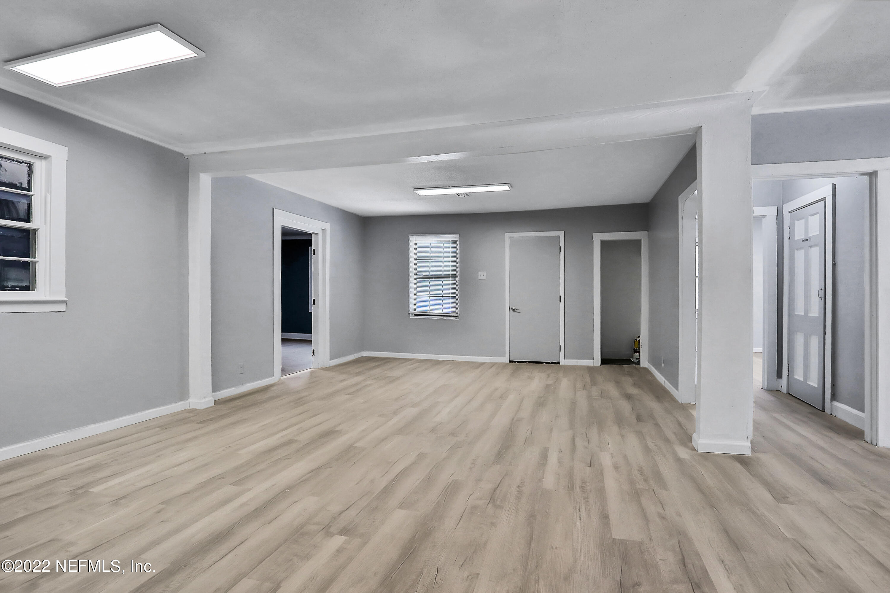 5645 St Augustine Road Jacksonville, FL 32207 - Photo 8 of 11 a view of an empty room with wooden floor and a window