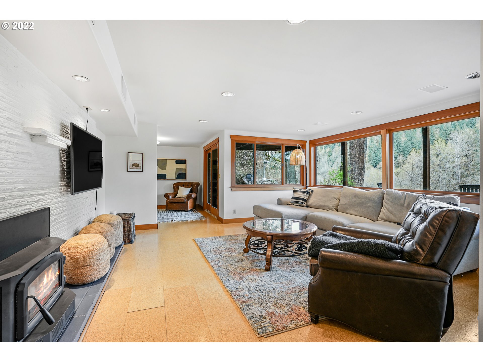 35719 Southeast Lusted Road Boring, OR 97009 - Photo 23 of 32 a living room with furniture a flat screen tv and a floor to ceiling window