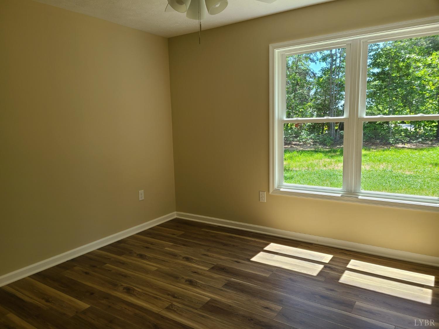 2429 Stonewall Road Concord, VA 24538 - Photo 13 of 16 a view of empty room with wooden floor and fan