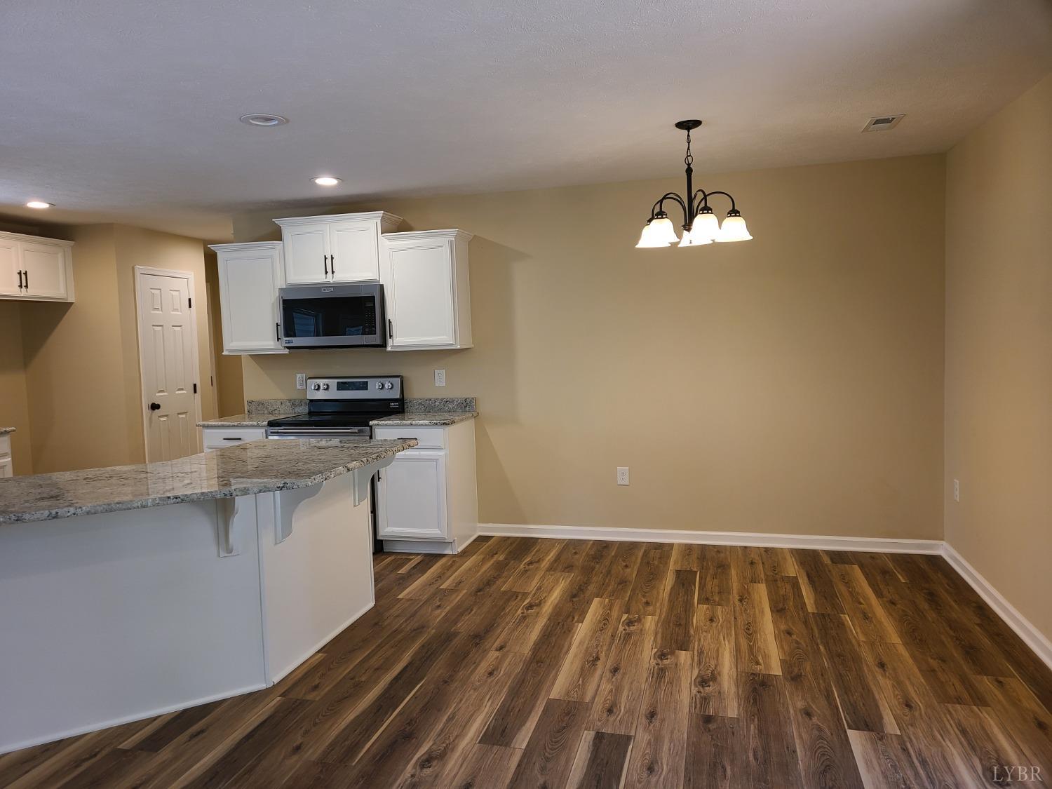 2429 Stonewall Road Concord, VA 24538 - Photo 4 of 16 a kitchen with microwave a stove and cabinets
