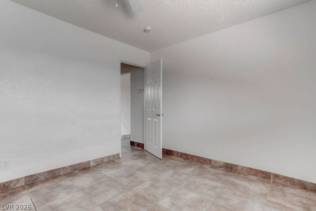 421 North Decatur Boulevard, Unit 2 Las Vegas, NV 89107 - Photo 20 of 21 Functional room features durable tile flooring and crisp white walls, awaiting your personal touch.
