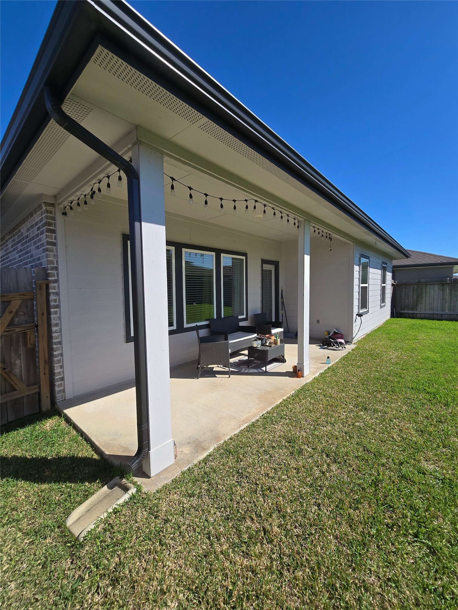 7722 Caspian Ranch Drive Rosharon, TX 77583 - Photo 13 of 15 a view of a patio with table and chairs potted plants and floor to ceiling window