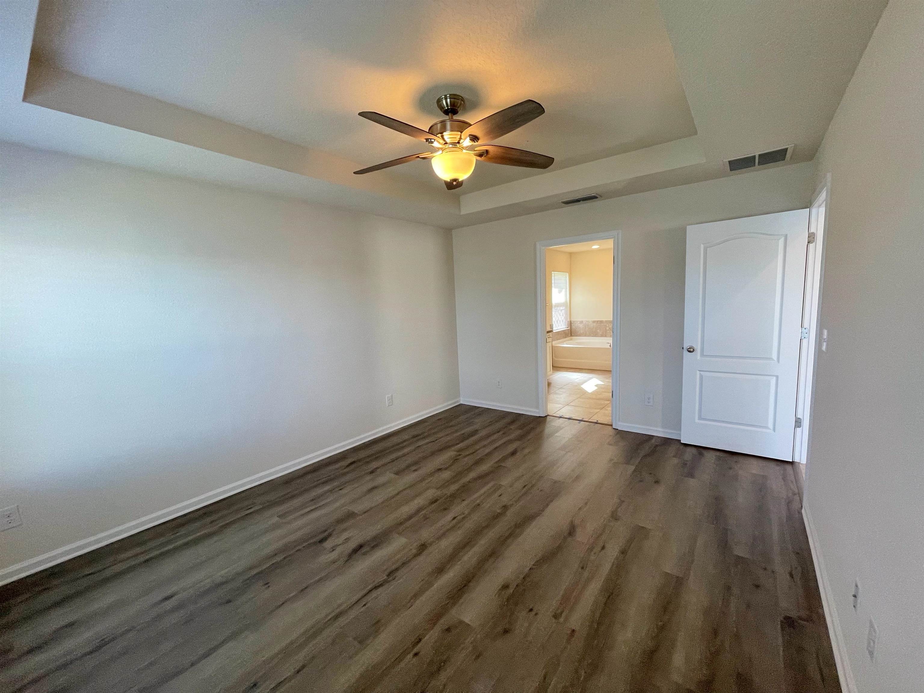 578 Deer Crossing Road St. Augustine, FL 32086 - Photo 13 of 28 wooden floor in an empty room with a window