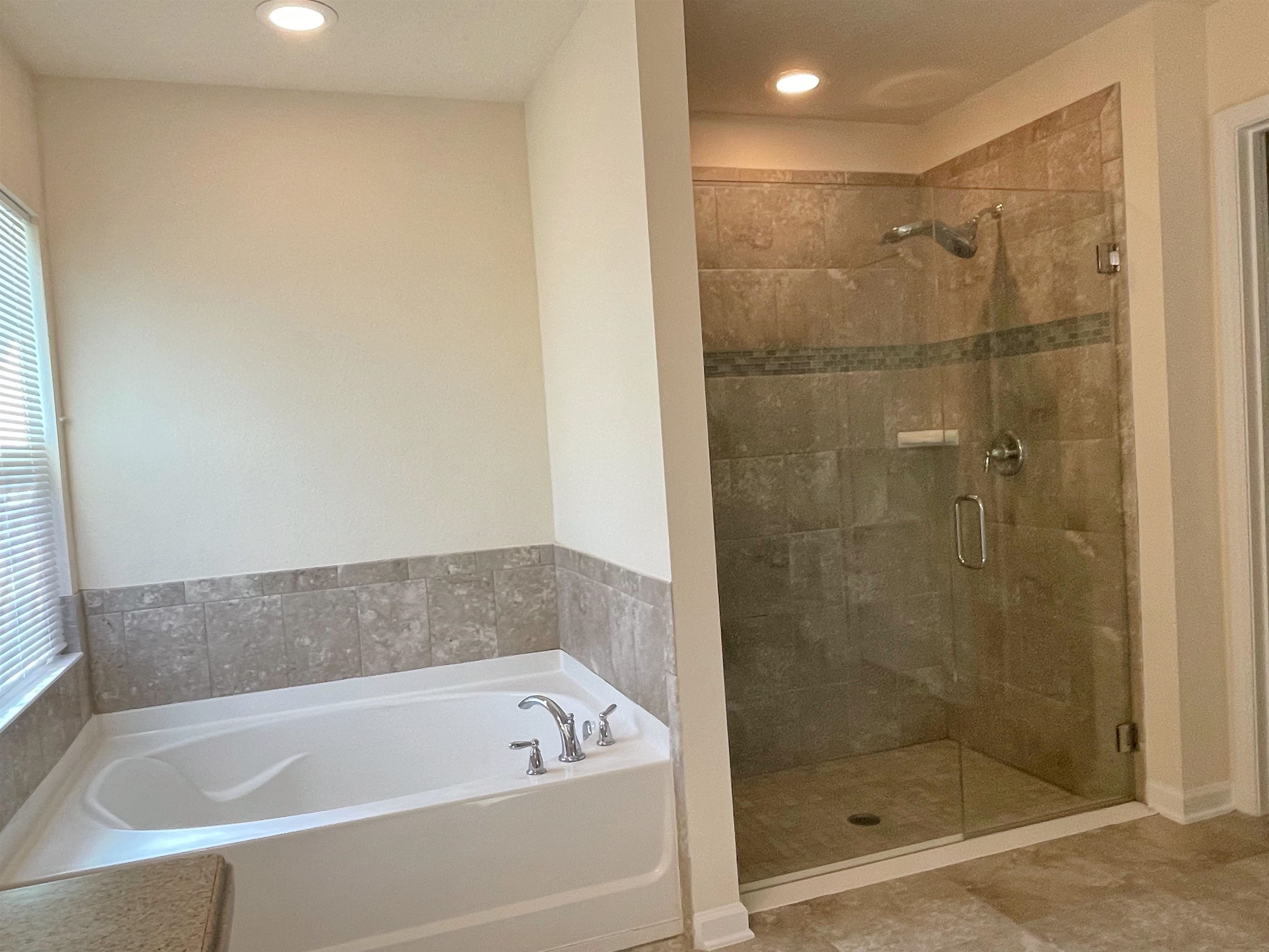 578 Deer Crossing Road St. Augustine, FL 32086 - Photo 15 of 28 a bathroom with a bathtub and a shower