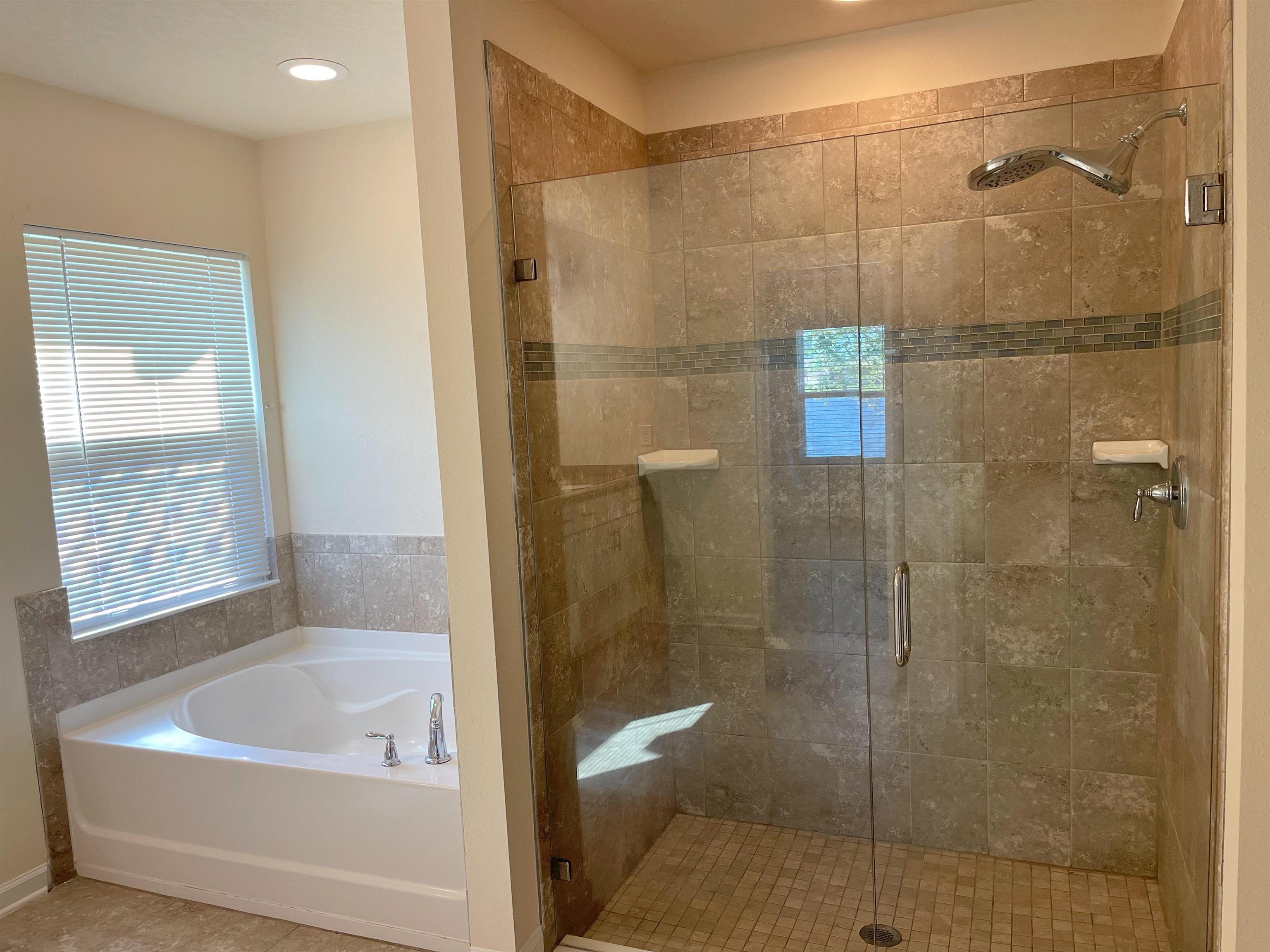 578 Deer Crossing Road St. Augustine, FL 32086 - Photo 16 of 28 a bathroom with a bathtub and a shower