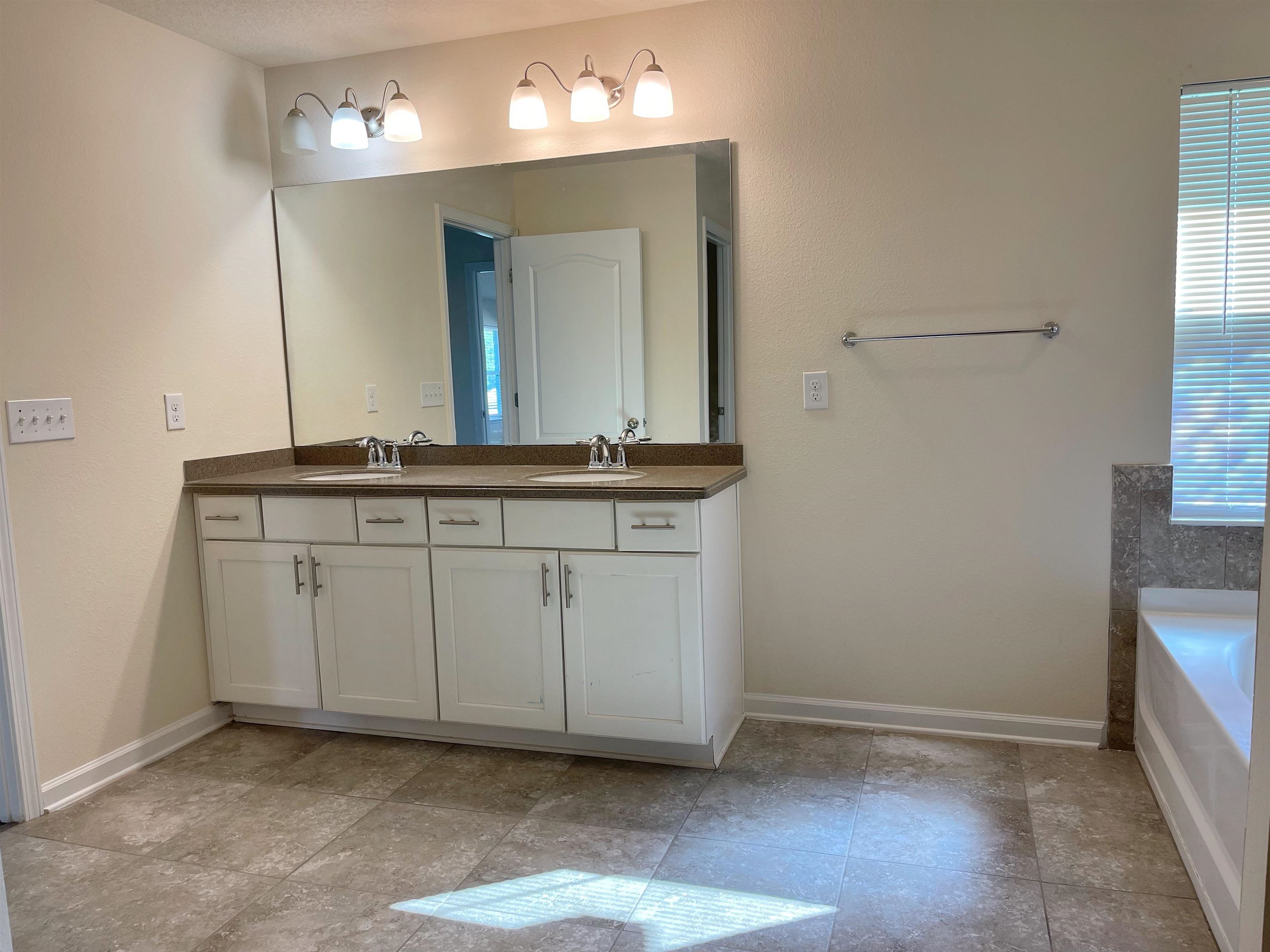 578 Deer Crossing Road St. Augustine, FL 32086 - Photo 17 of 28 a view of a double sink and a mirror