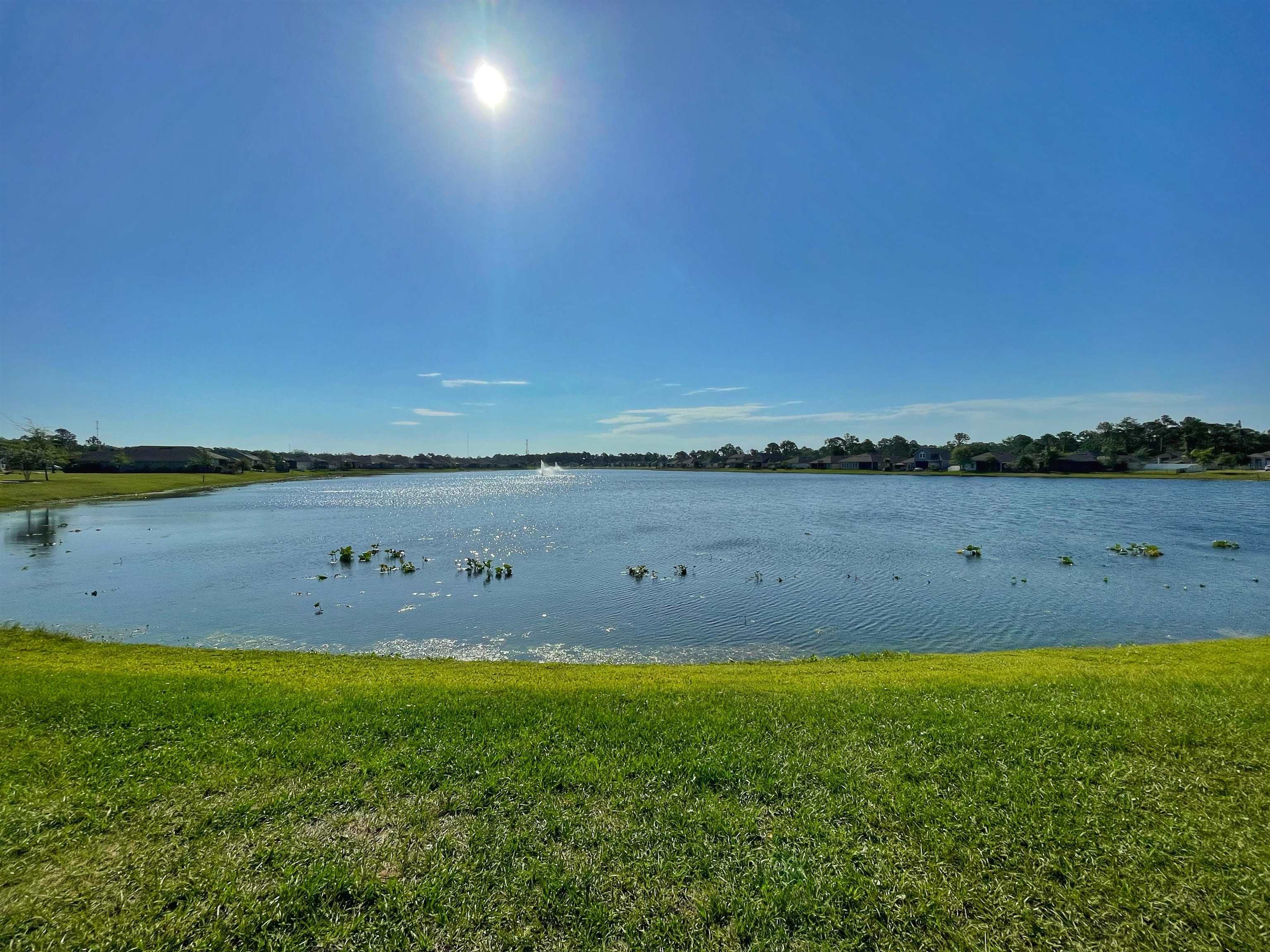 578 Deer Crossing Road St. Augustine, FL 32086 - Photo 22 of 28 a view of a lake with houses in the background