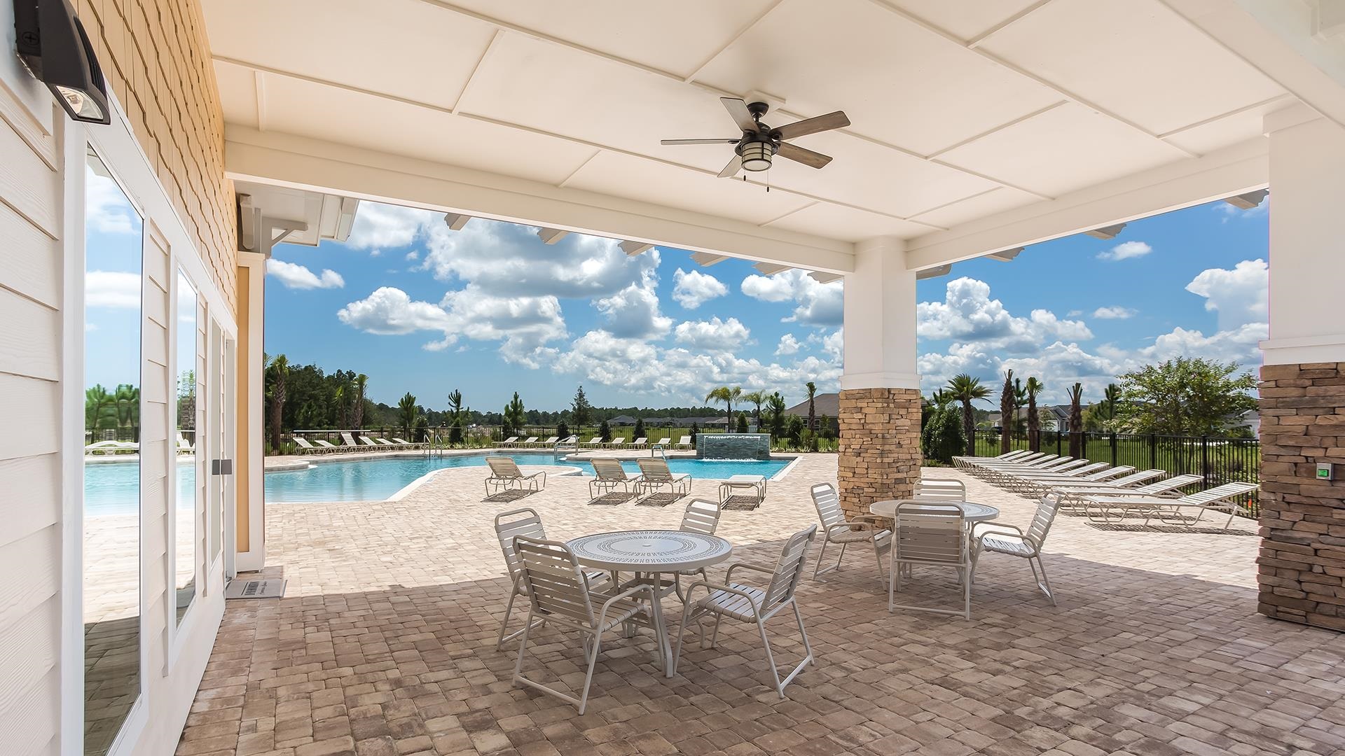 578 Deer Crossing Road St. Augustine, FL 32086 - Photo 26 of 28 a outdoor space with lots of tables a chair and a chandelier