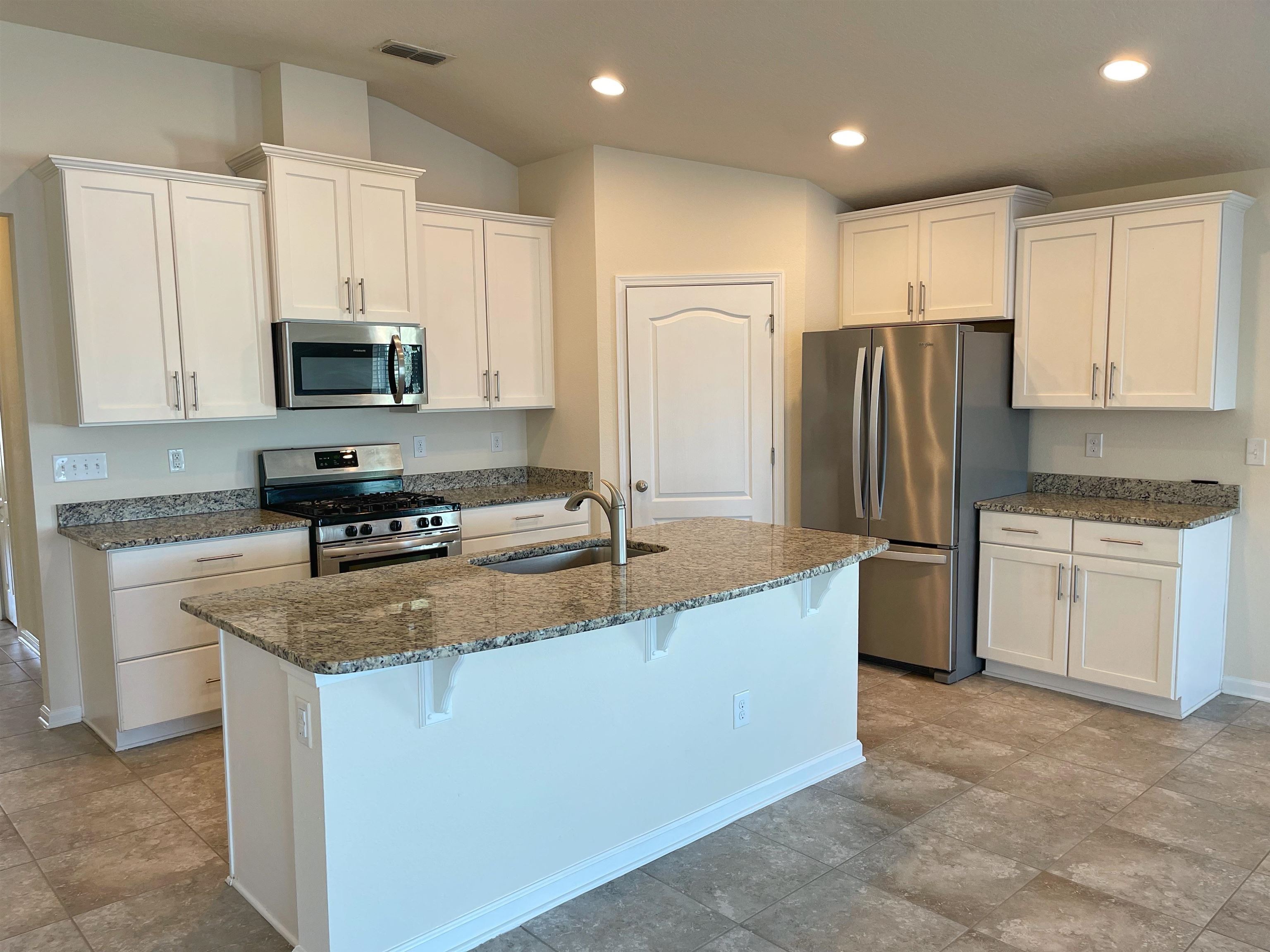 578 Deer Crossing Road St. Augustine, FL 32086 - Photo 5 of 28 a kitchen with stainless steel appliances granite countertop a refrigerator sink and stove