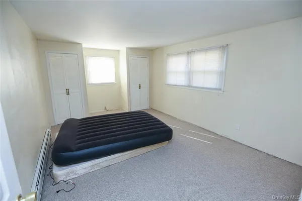 a view of a room with wooden floor and window
