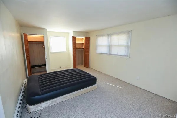 a view of an empty room and wooden floor