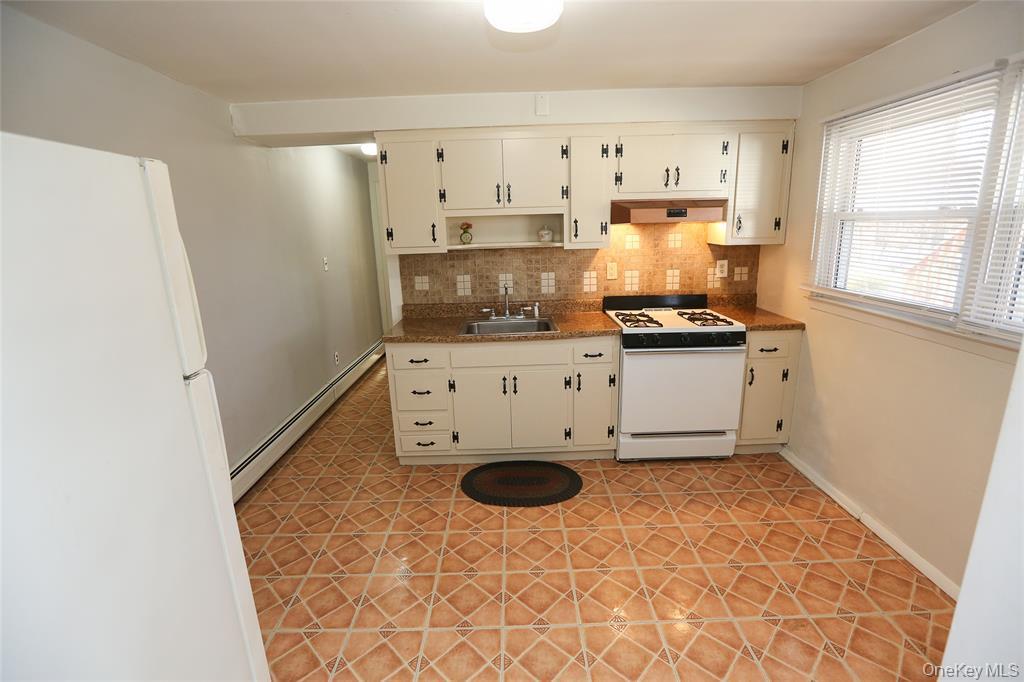 40 Bluefields Lane Blauvelt, NY 10913 - Photo 9 of 11 a kitchen with stainless steel appliances granite countertop a stove a refrigerator and a sink