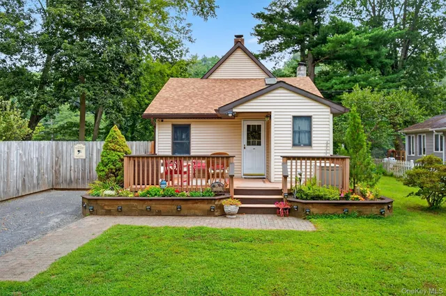 a house view with a garden and deck