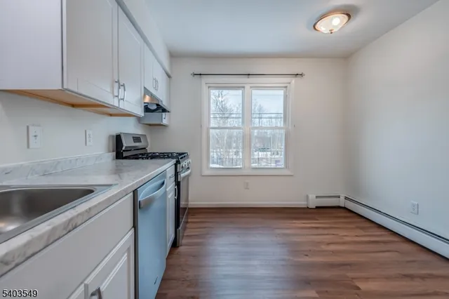 a kitchen that has a sink and a stove