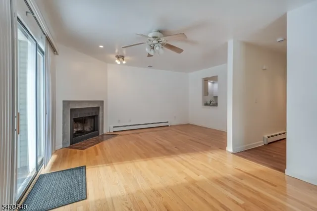 a bed room with a fireplace and window
