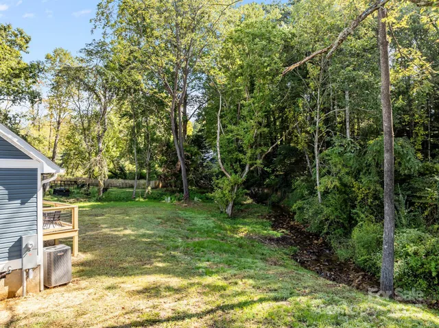 a view of balcony with wooden floor and fence
