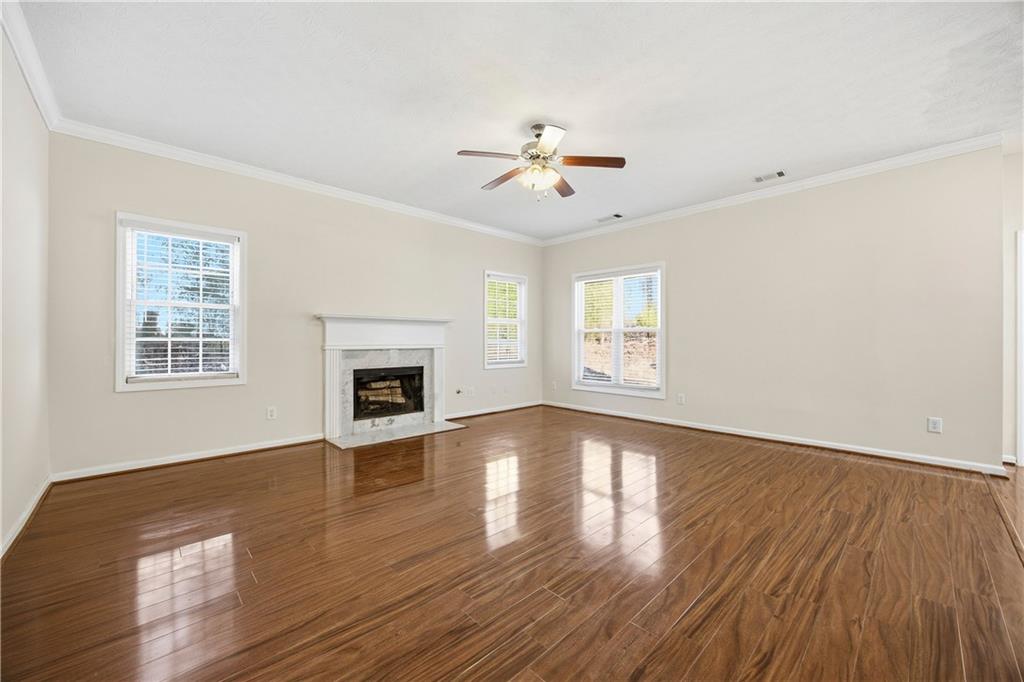 3393 Morning Top Place Suwanee, GA 30024 - Photo 13 of 34 a view of empty room with wooden floor and fan