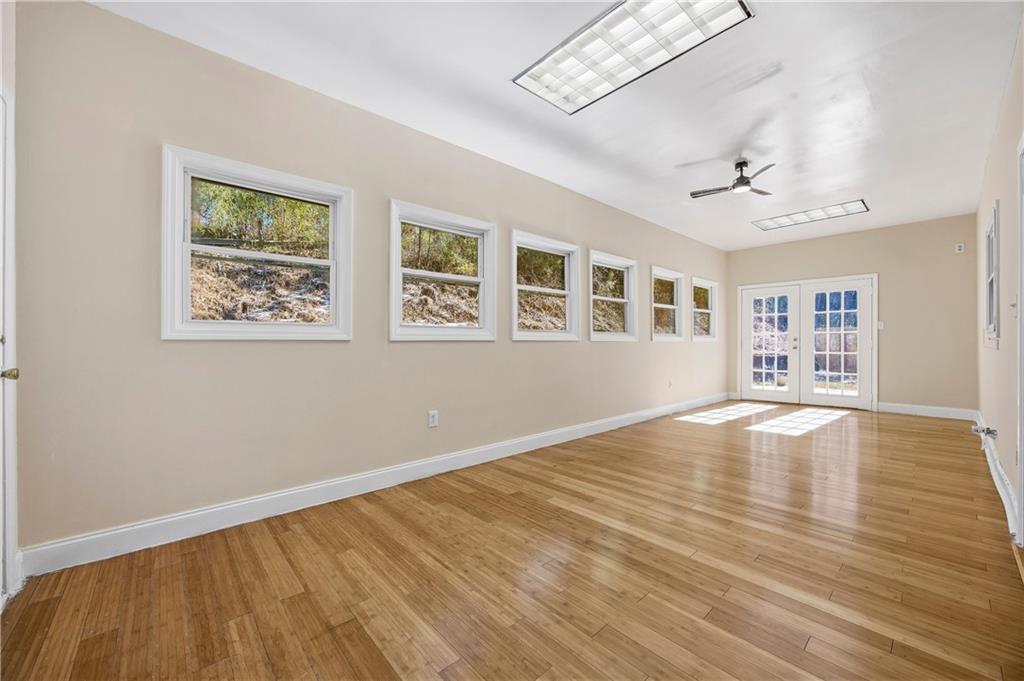 3393 Morning Top Place Suwanee, GA 30024 - Photo 18 of 34 a view of an empty room with wooden floor and a window