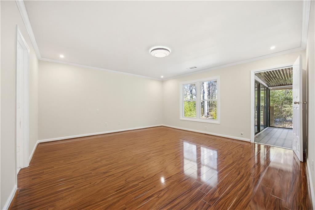 3393 Morning Top Place Suwanee, GA 30024 - Photo 19 of 34 wooden floor in an empty room with a window