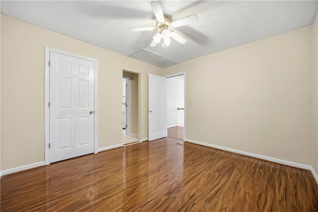 3393 Morning Top Place Suwanee, GA 30024 - Photo 28 of 34 an empty room with wooden floor and windows