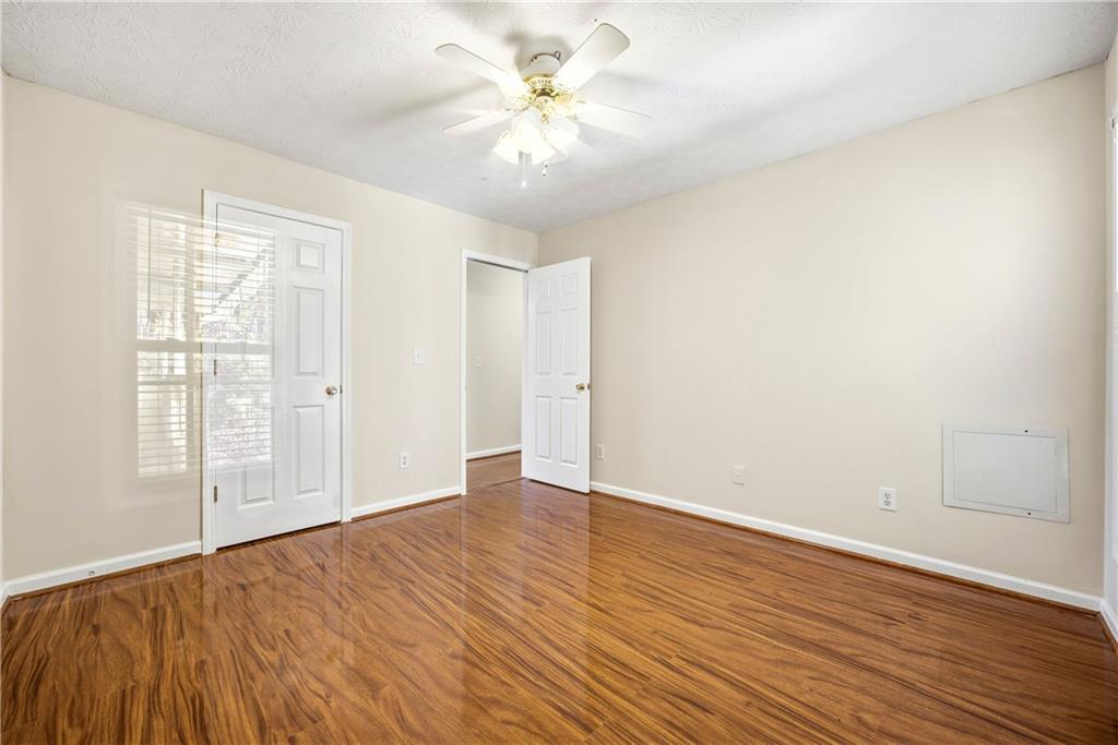 3393 Morning Top Place Suwanee, GA 30024 - Photo 30 of 34 wooden floor in an empty room with a window