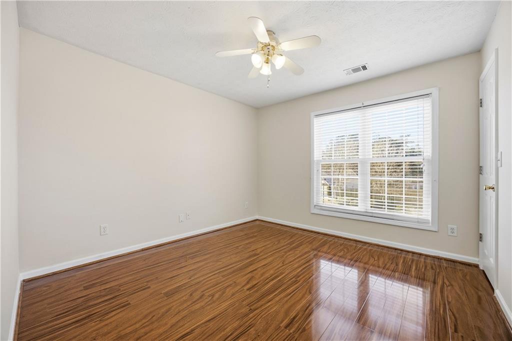 3393 Morning Top Place Suwanee, GA 30024 - Photo 31 of 34 an empty room with wooden floor and windows
