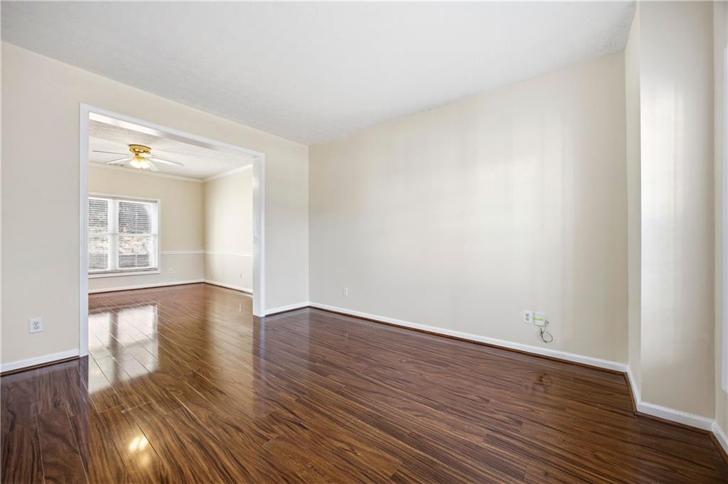 3393 Morning Top Place Suwanee, GA 30024 - Photo 5 of 34 a view of wooden floor and windows in an empty room