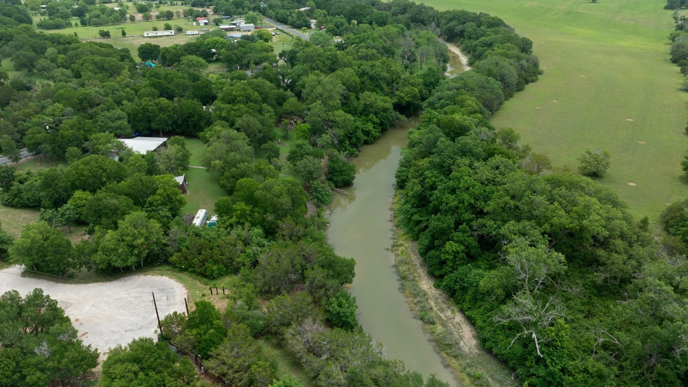 1620 San Gabriel Ranch Road Liberty Hill, TX 78642 - Photo 21 of 34 an aerial view of residential house with outdoor space and trees all around