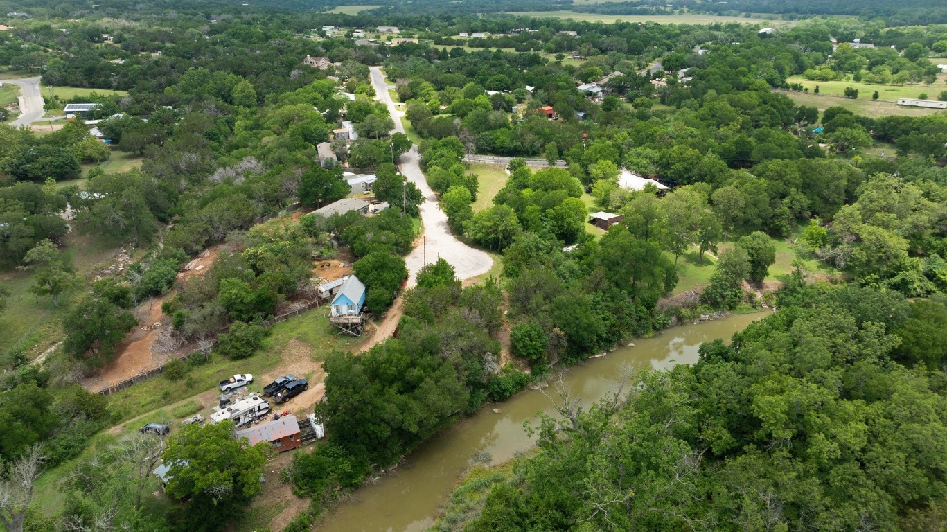 1620 San Gabriel Ranch Road Liberty Hill, TX 78642 - Photo 22 of 34 an aerial view of residential houses with outdoor space and trees