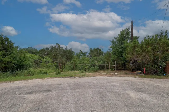a view of a field with trees in background