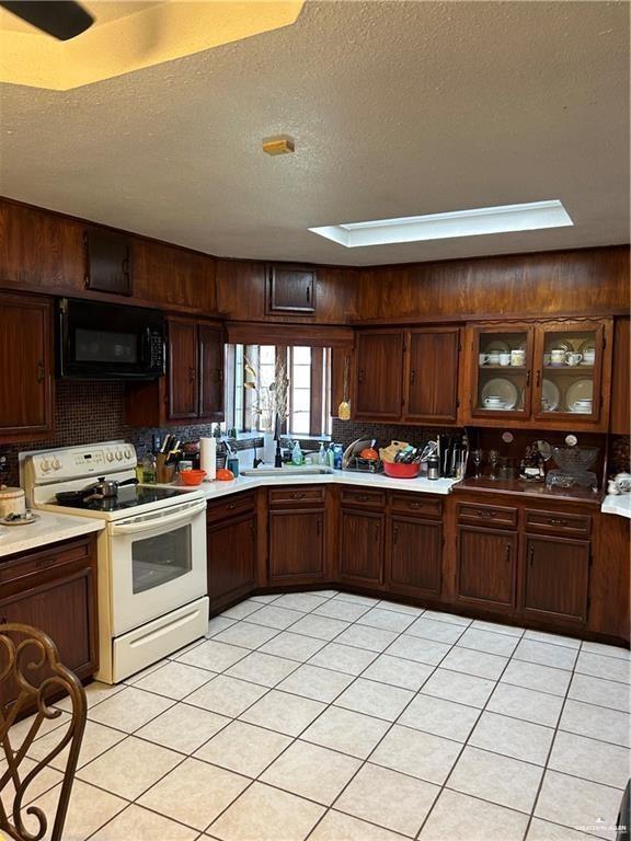 9433 North Minnesota Road Mission, TX 78574 - Photo 13 of 18 a kitchen with a stove top oven and cabinets