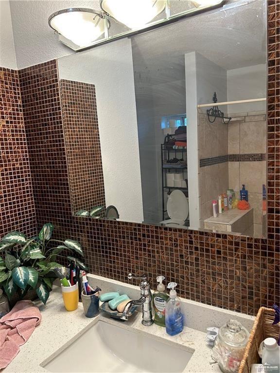 9433 North Minnesota Road Mission, TX 78574 - Photo 16 of 18 a bathroom with a sink and a mirror