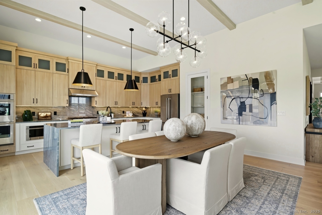 6 Thorncrest Ridge, Unit 72 Danbury, CT 06810 - Photo 2 of 16 a kitchen with stainless steel appliances granite countertop a sink a stove and a wooden floor