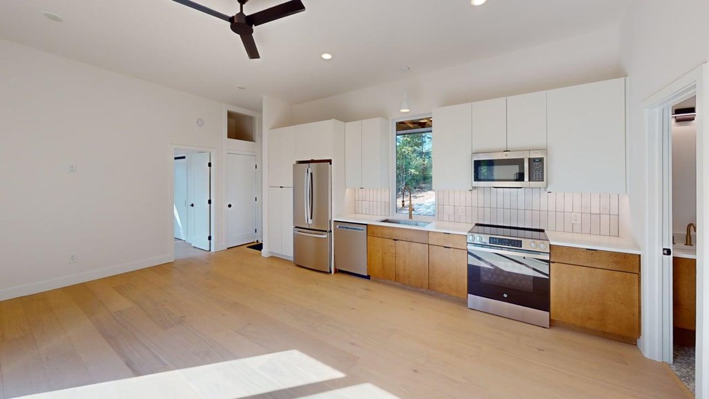 531 Brannon Ridge Young Harris, GA 30582 - Photo 5 of 12 a kitchen with stainless steel appliances white cabinets and wooden floor