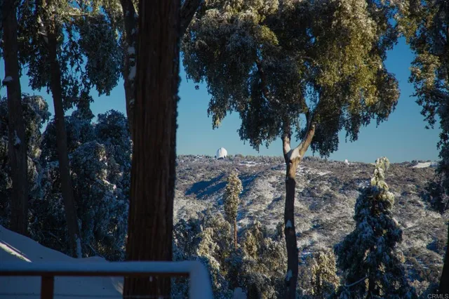 a view of workspace with wooden floor and windows