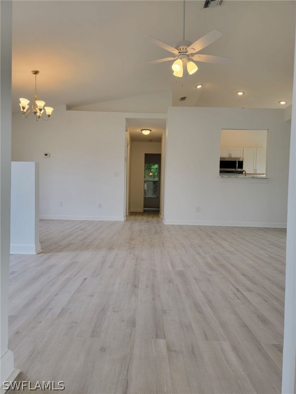 17565 Braddock Road Fort Myers, FL 33967 - Photo 5 of 19 wooden floor in an empty room with a window