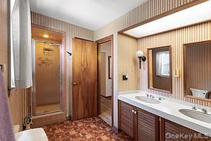 178 Barnes Road, Unit MAIN HOUSE Brookhaven, NY 11955 - Photo 14 of 17 a bathroom with a double vanity sink mirror double and shower