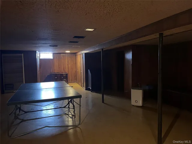 a dining room with furniture a chandelier and wooden floor