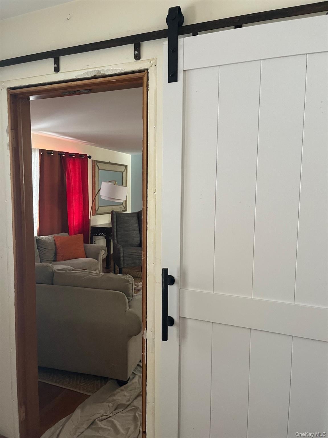 178 Barnes Road, Unit MAIN HOUSE Brookhaven, NY 11955 - Photo 6 of 17 a living room with a couch and a wooden floor