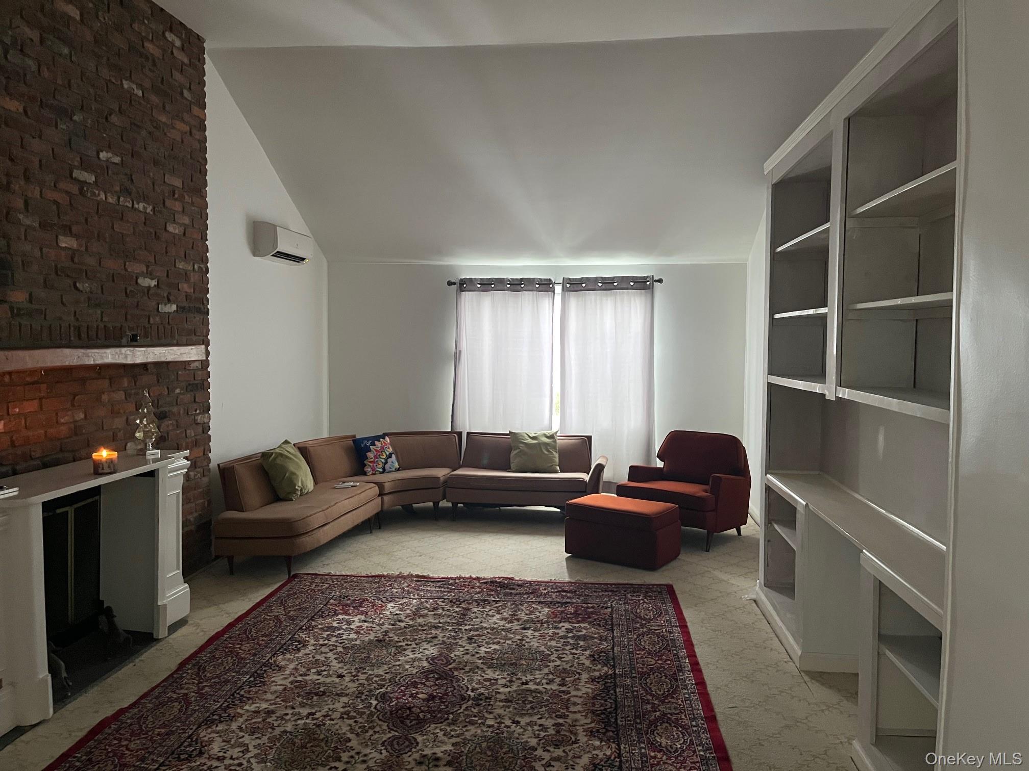 178 Barnes Road, Unit MAIN HOUSE Brookhaven, NY 11955 - Photo 8 of 17 a living room with furniture and a flat screen tv